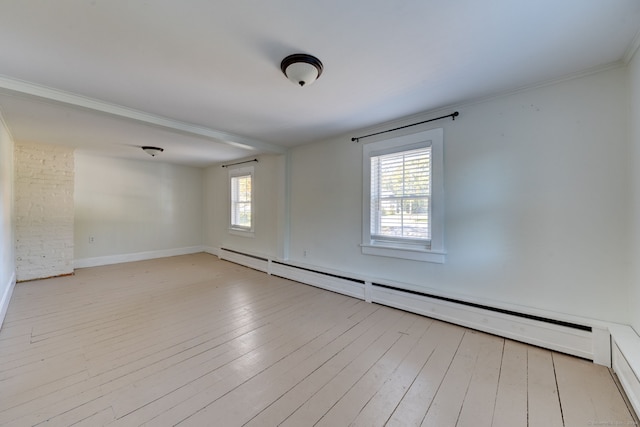 empty room featuring light hardwood / wood-style floors, ornamental molding, and a baseboard radiator