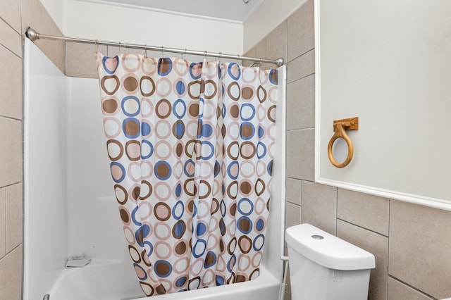 bathroom featuring shower / bath combo with shower curtain, tile walls, and toilet