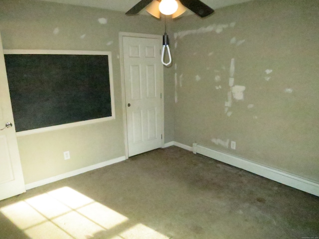 spare room featuring baseboard heating, ceiling fan, and carpet floors