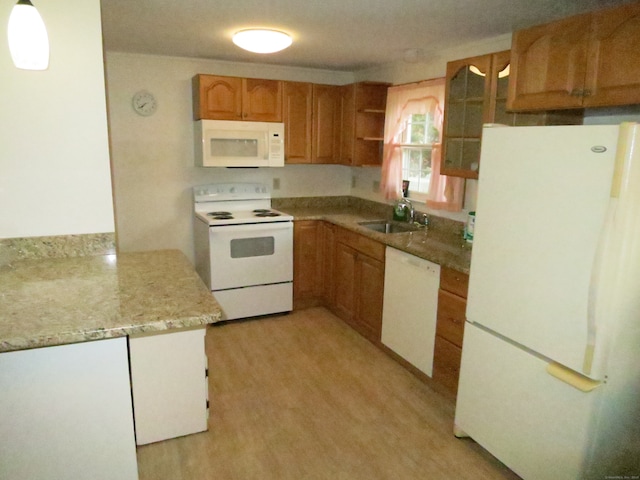 kitchen with white appliances, light hardwood / wood-style floors, and sink