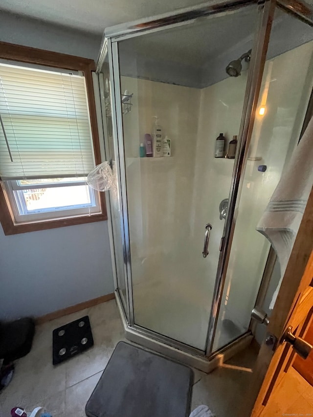 bathroom with a shower with door