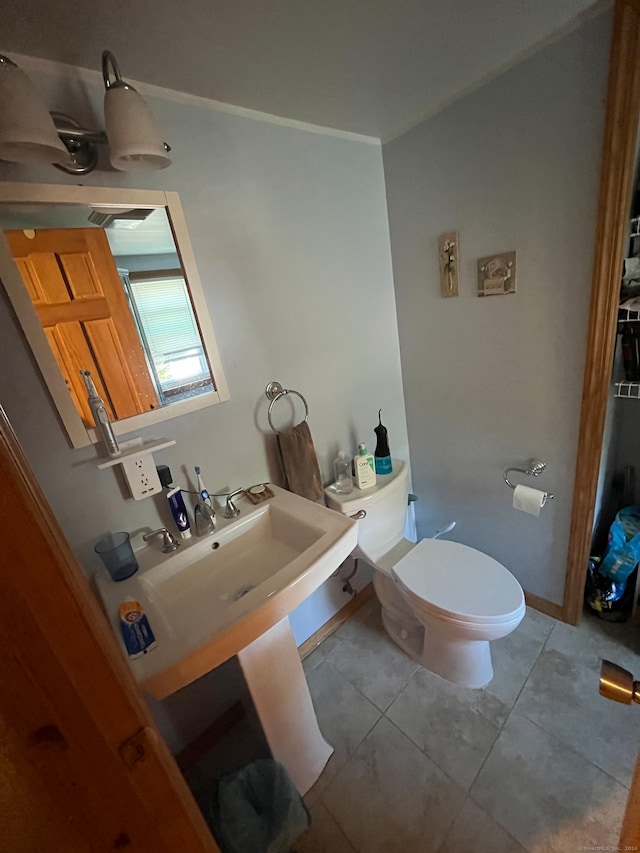 bathroom with tile patterned flooring and toilet