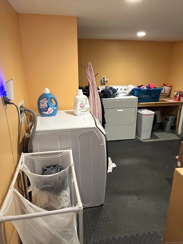 laundry area featuring washing machine and clothes dryer and dark colored carpet