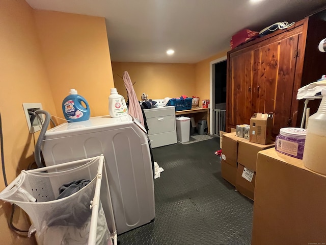 laundry room featuring washing machine and clothes dryer and dark carpet