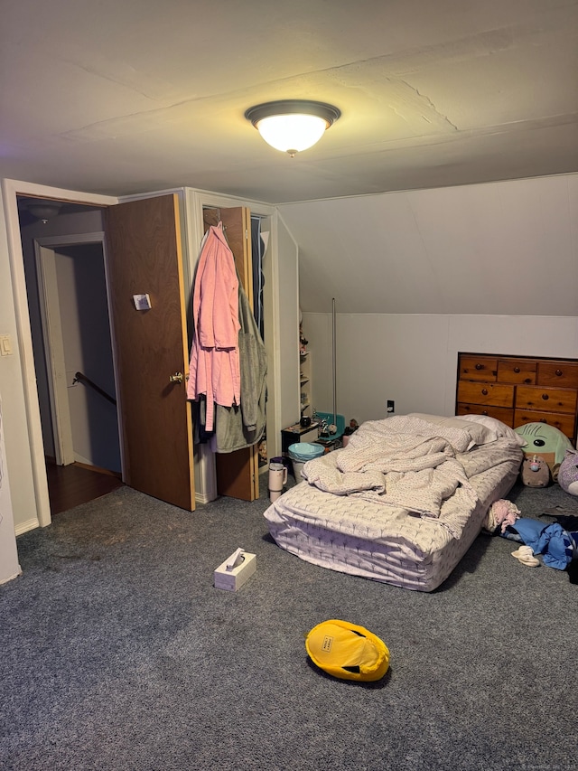 carpeted bedroom featuring lofted ceiling