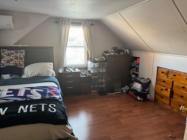 bedroom featuring a wall unit AC, lofted ceiling, and dark hardwood / wood-style flooring