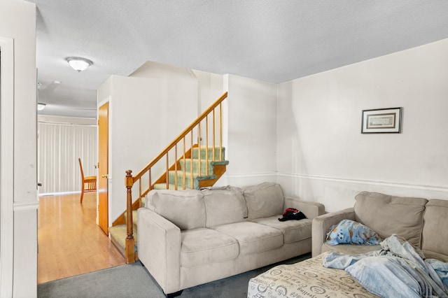 living room featuring a textured ceiling and hardwood / wood-style flooring