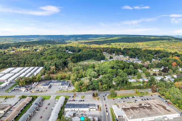 drone / aerial view featuring a forest view