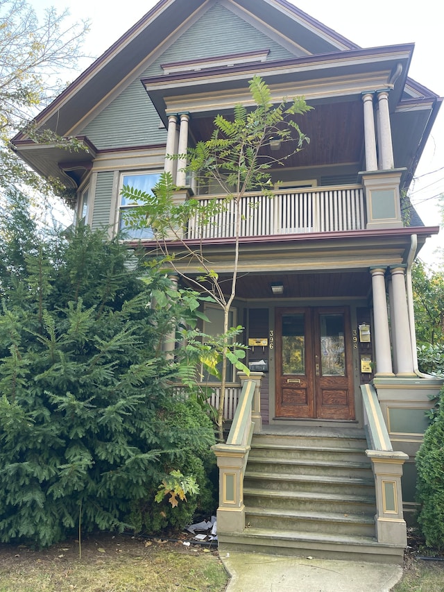 view of front facade featuring a balcony and french doors