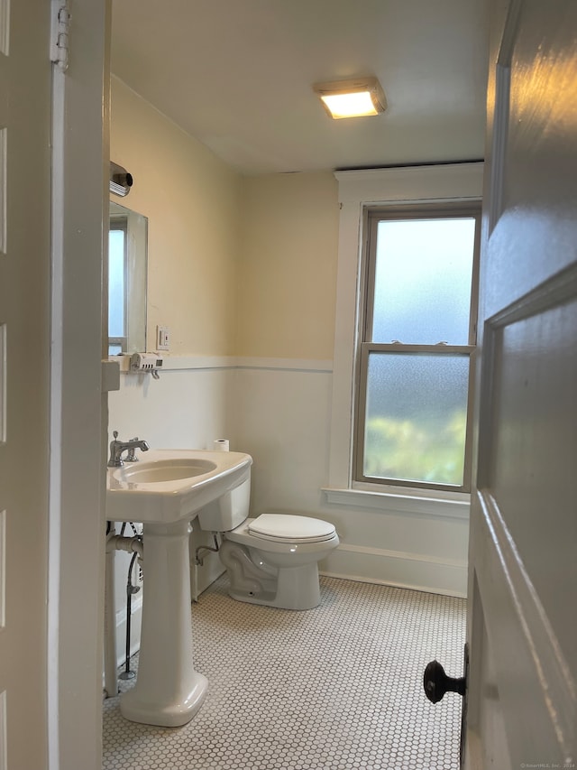 bathroom with tile patterned flooring, toilet, and sink