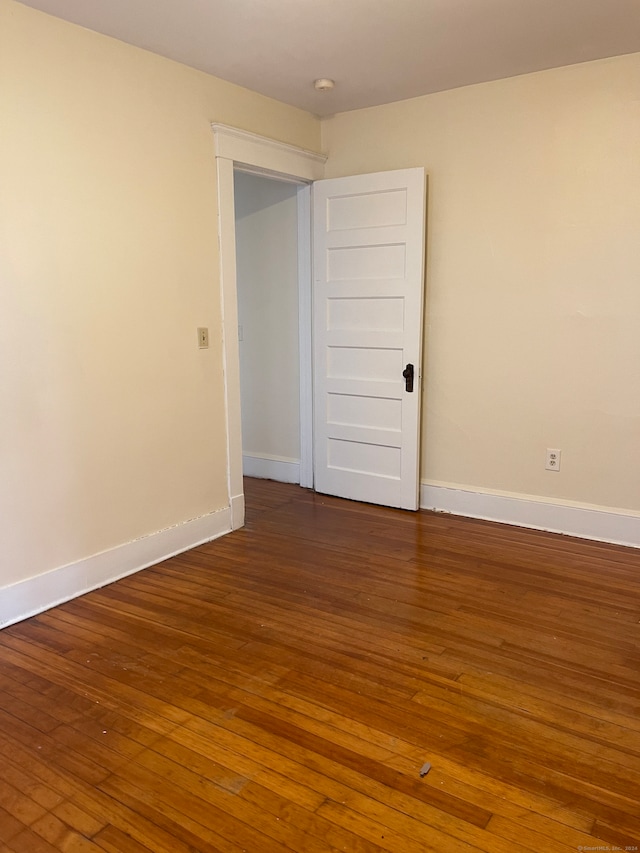 spare room with dark hardwood / wood-style flooring