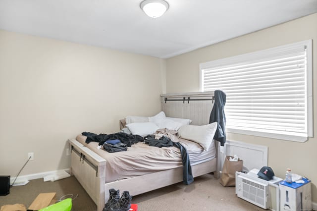 carpeted bedroom featuring multiple windows