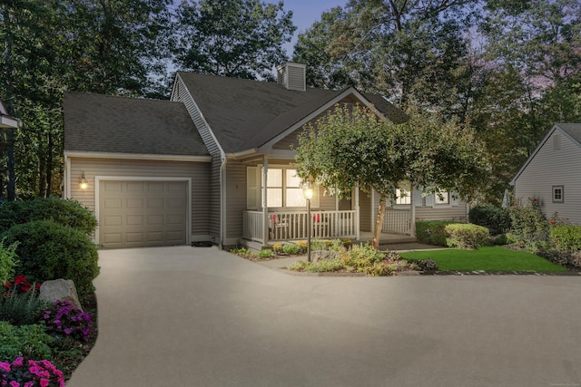 view of front of house featuring a porch and a garage