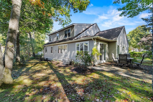 rear view of property featuring central AC unit and a patio area