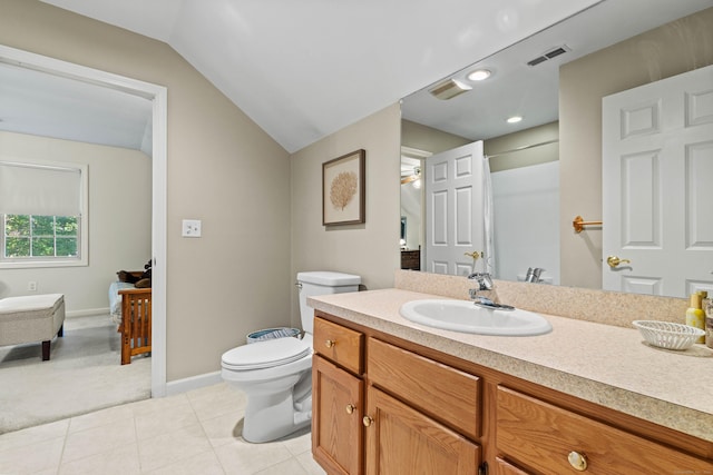 bathroom with ceiling fan, toilet, vanity, and vaulted ceiling