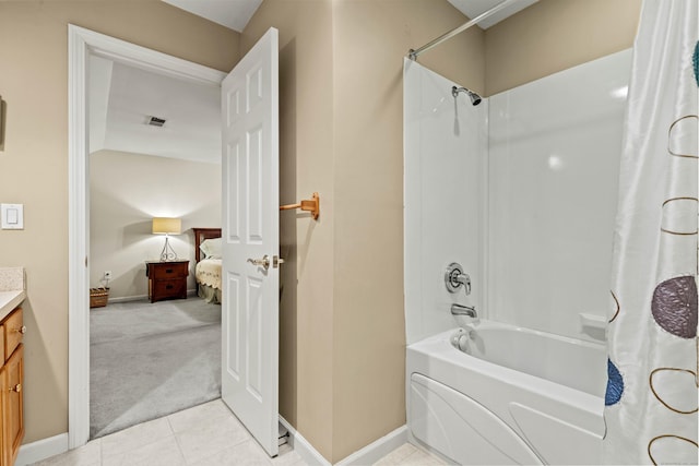 bathroom with shower / bath combo with shower curtain, vanity, and tile patterned flooring