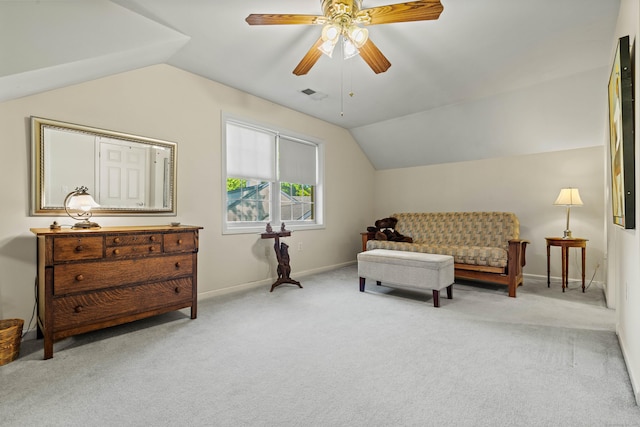 living area with ceiling fan, light colored carpet, and lofted ceiling