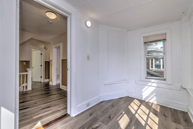 unfurnished room with dark hardwood / wood-style flooring