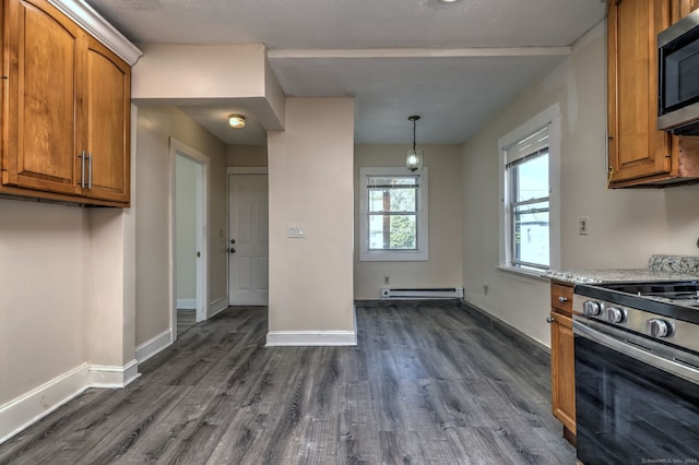 kitchen featuring stainless steel gas stove, baseboard heating, pendant lighting, dark wood-type flooring, and light stone counters