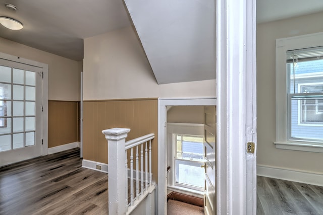 stairs with hardwood / wood-style flooring and lofted ceiling