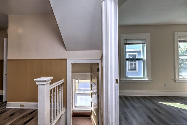 stairway featuring hardwood / wood-style floors and lofted ceiling