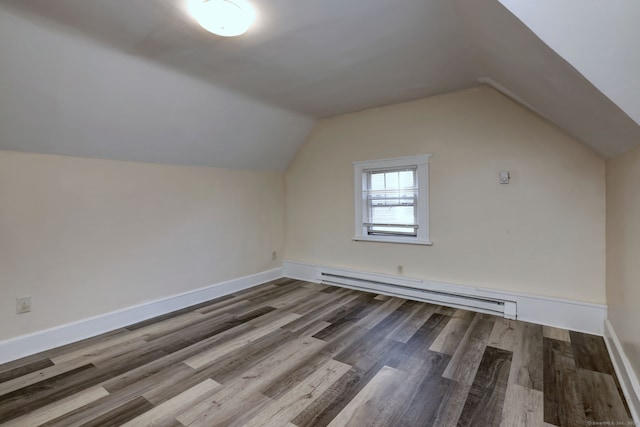 additional living space with hardwood / wood-style floors, a baseboard heating unit, and lofted ceiling