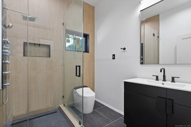 bathroom featuring toilet, vanity, tile patterned floors, and an enclosed shower