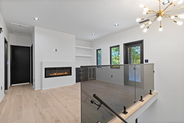 interior space with light hardwood / wood-style flooring and a notable chandelier