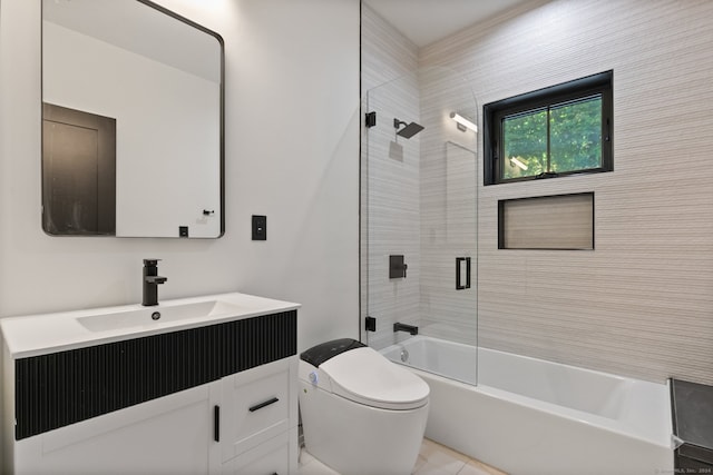 full bathroom featuring tile patterned flooring, vanity, bath / shower combo with glass door, and toilet