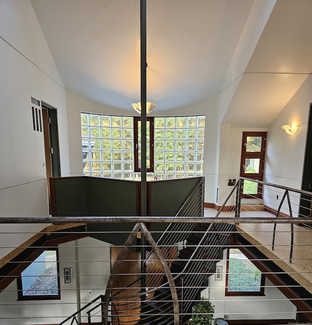 staircase featuring lofted ceiling