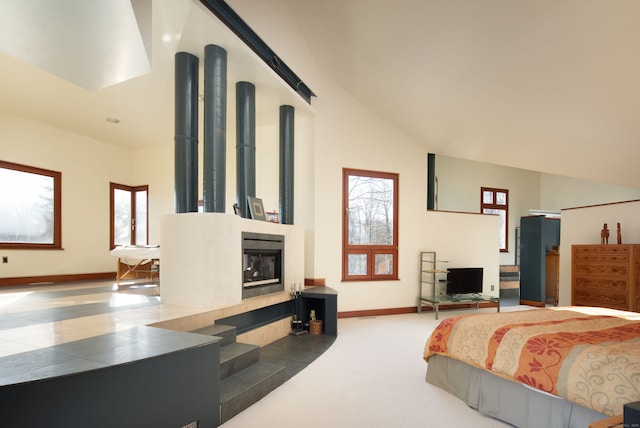 carpeted bedroom featuring high vaulted ceiling and multiple windows