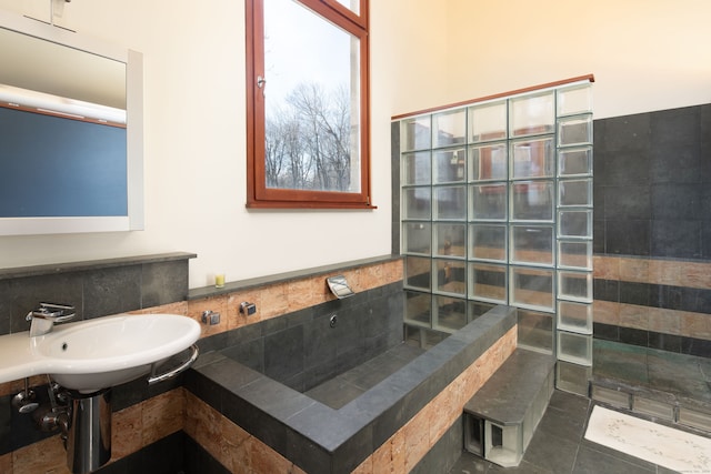 bathroom featuring sink, tile patterned flooring, and tasteful backsplash