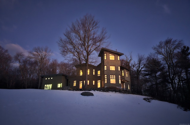 view of snow covered rear of property