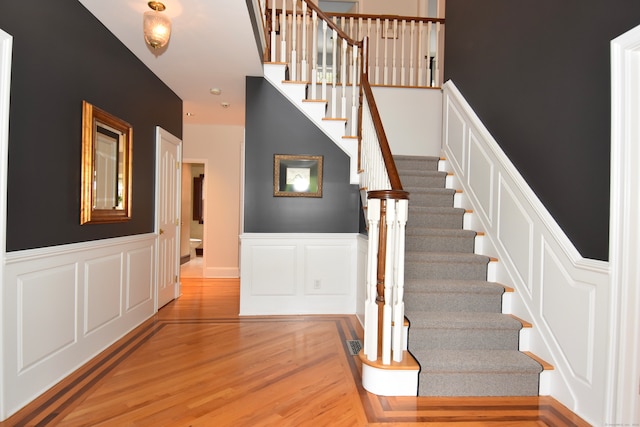 staircase with hardwood / wood-style flooring