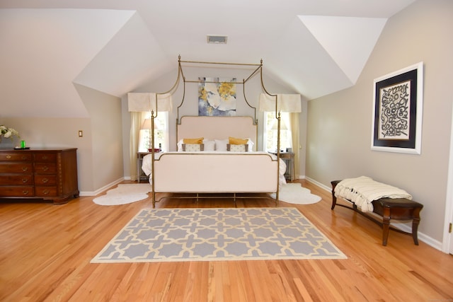 bedroom featuring wood-type flooring and lofted ceiling