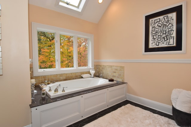 bathroom with a bathtub, tile patterned flooring, and lofted ceiling with skylight