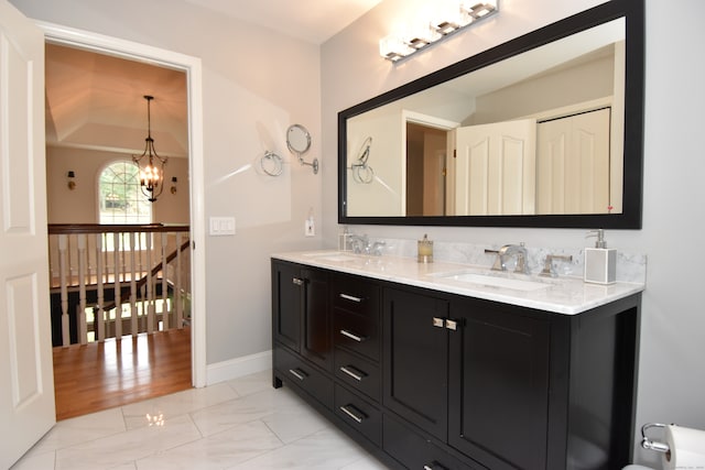 bathroom featuring hardwood / wood-style floors, vaulted ceiling, a chandelier, and vanity