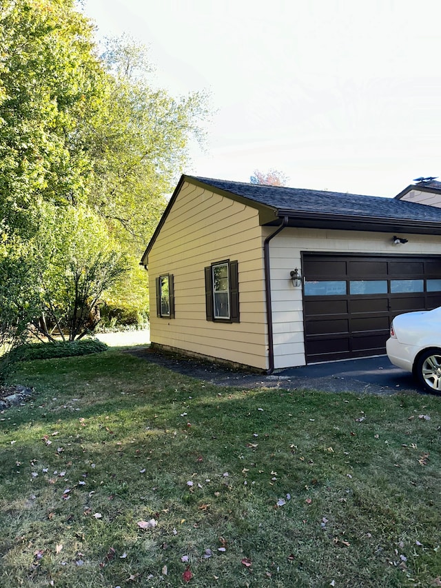 view of property exterior with a yard and a garage