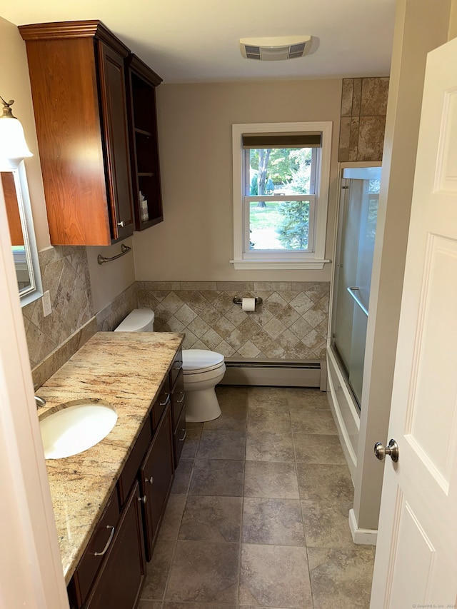 bathroom with backsplash, a shower with shower door, toilet, baseboard heating, and vanity