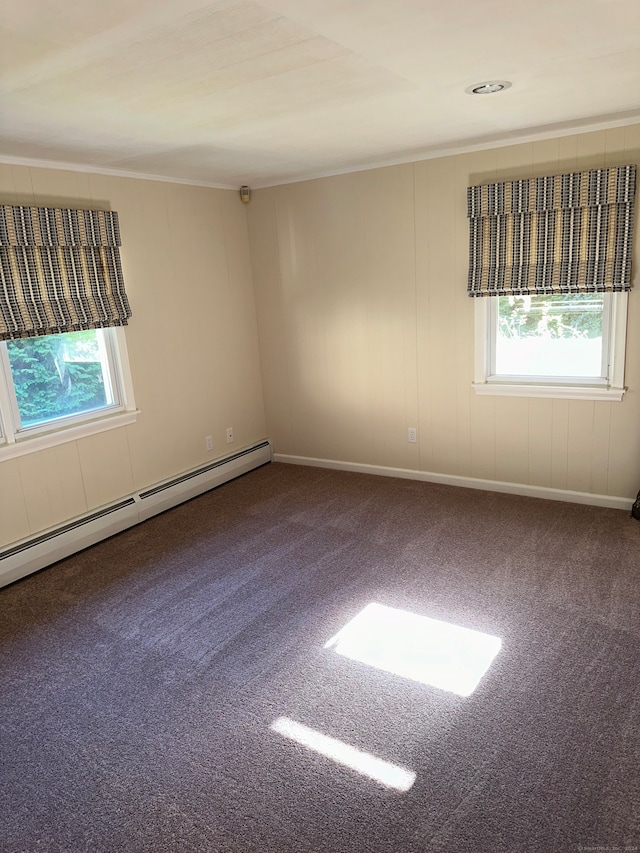 carpeted spare room with a baseboard radiator and a healthy amount of sunlight