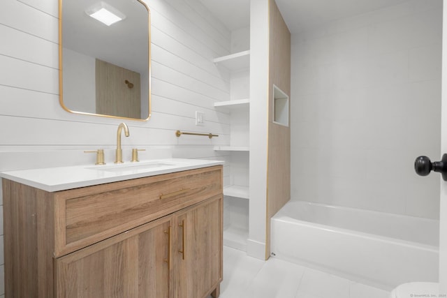 bathroom with tile patterned flooring, vanity, wood walls, and washtub / shower combination