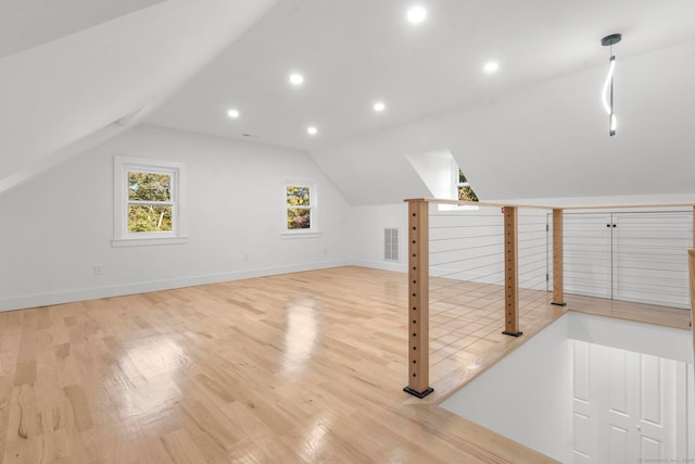 bonus room featuring vaulted ceiling and light wood-type flooring