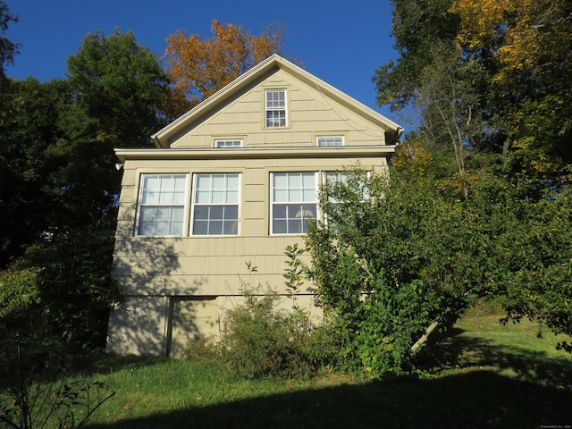 view of home's exterior featuring a lawn