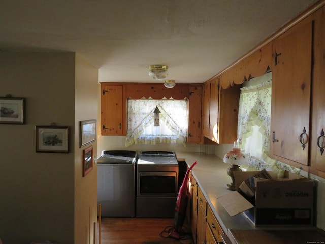 laundry room featuring dark hardwood / wood-style floors and washer and clothes dryer