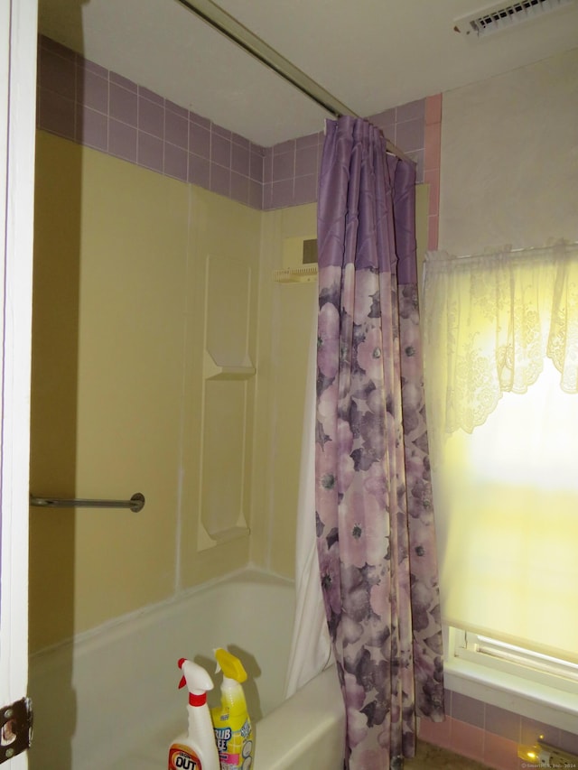 bathroom featuring shower / bath combination with curtain