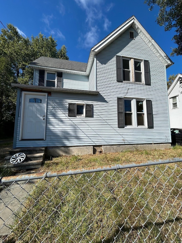 back of house with cooling unit and a yard