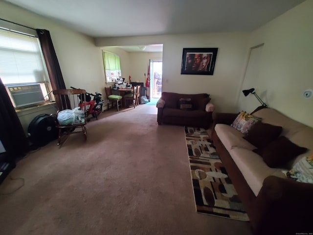 living room featuring carpet floors, cooling unit, and plenty of natural light