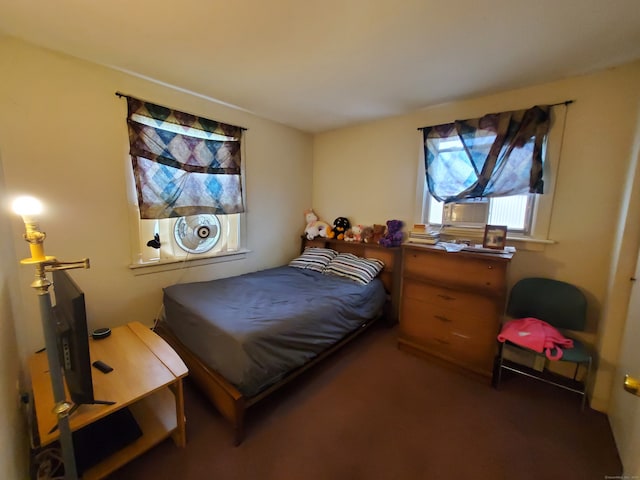 bedroom featuring dark carpet