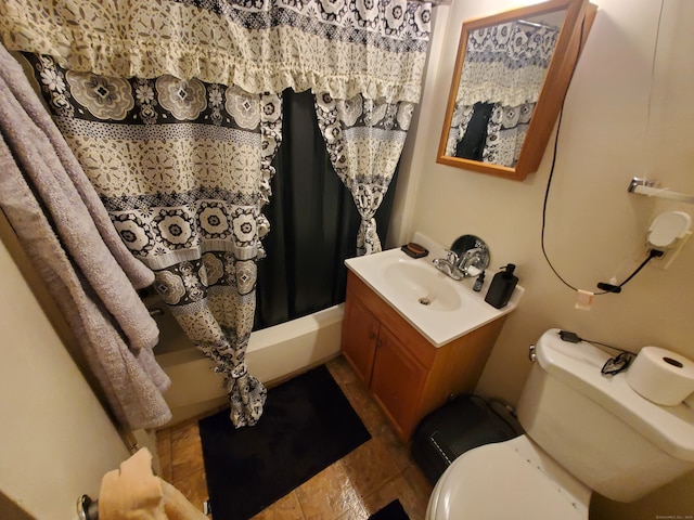 bathroom featuring walk in shower, vanity, toilet, and tile patterned floors