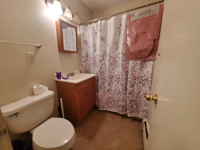 bathroom featuring vanity, toilet, baseboard heating, tile patterned flooring, and a shower with shower curtain